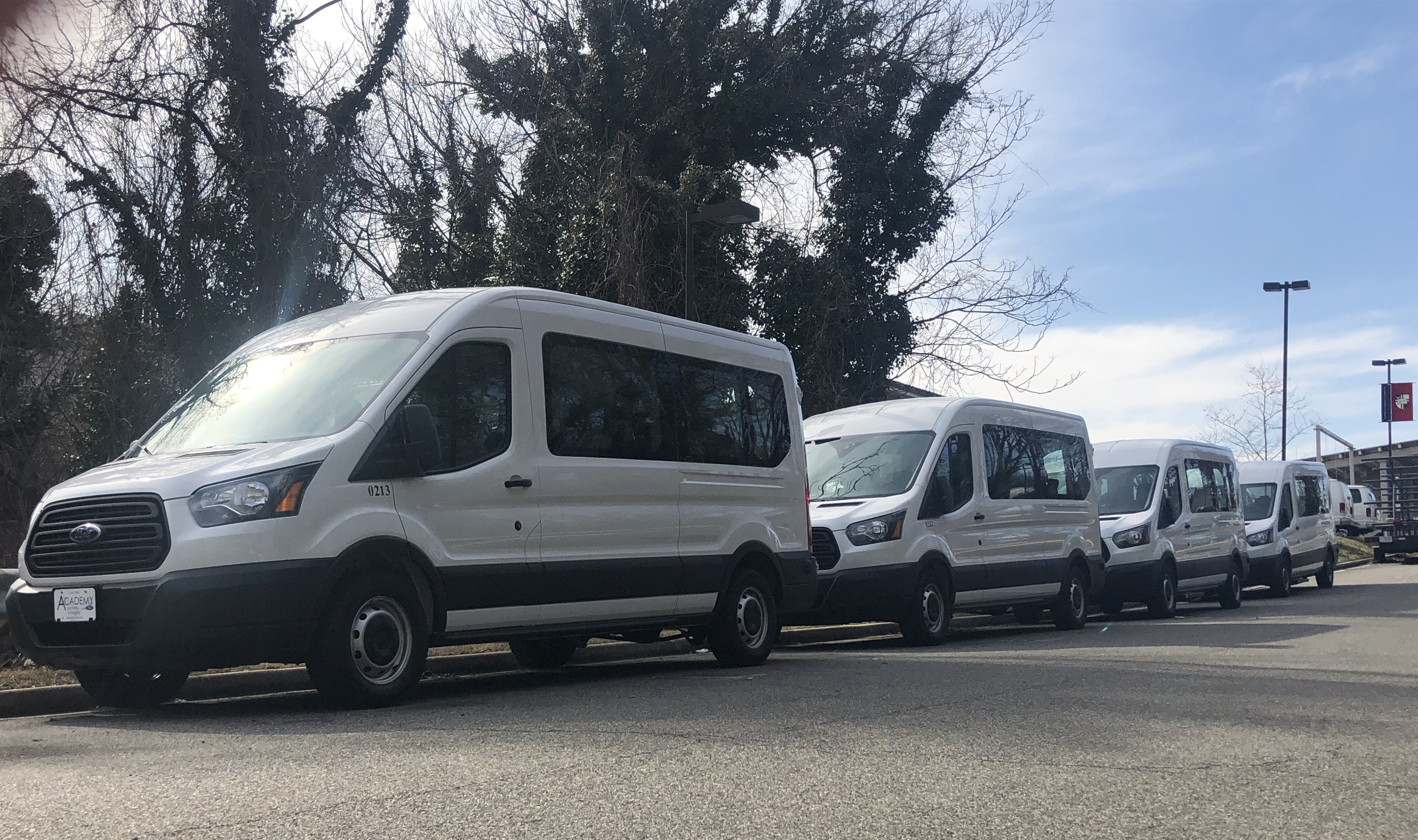 Campus Shuttle driving under cherry blossos